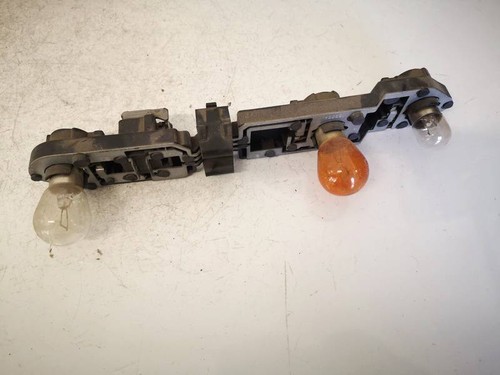 Tail light bulb cover holder