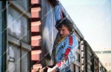 35m-16031 Kelly Johnson hanging from a train film Goodbye Pork Pie 35m-16031 35m