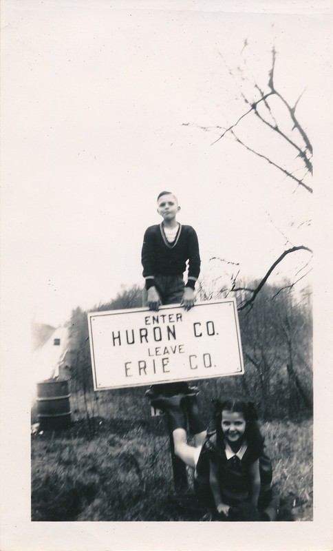vintage snapshot photo: Roadside Huron Erie Ohio County Road Sign w/ Boy & Girl