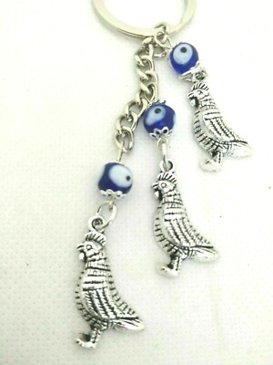 Schlüsselanhänger Tauben versilbert in Zink mit blauen Perlen Evil Eye, Details in Bio