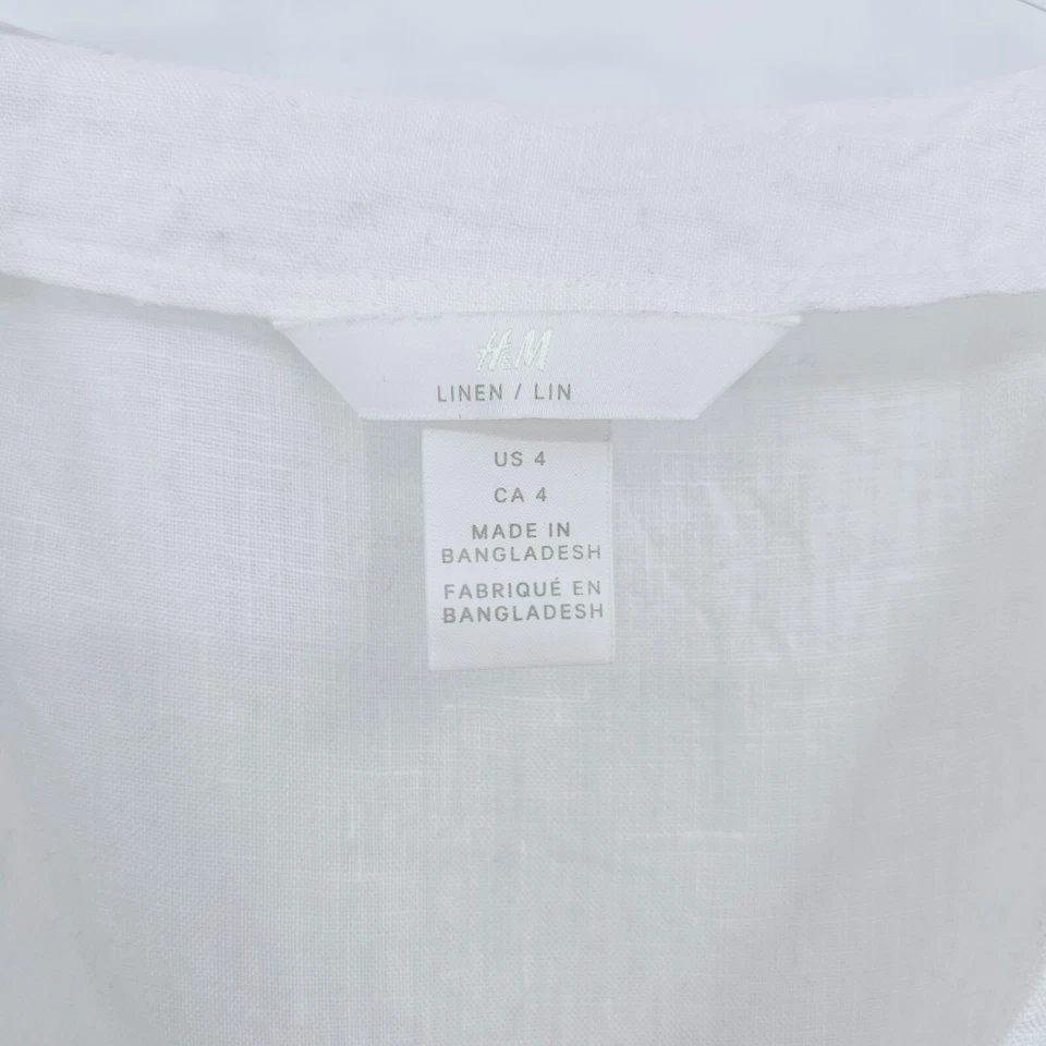 Top envolvente H&M 100 % lino peplum 4 botones blancos recortados madreperla lazo cintura Foto 2 de 4