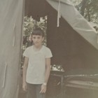 Vintage Color Photo Snapshot of Young Boy Scout Member Standing in Tent Outside