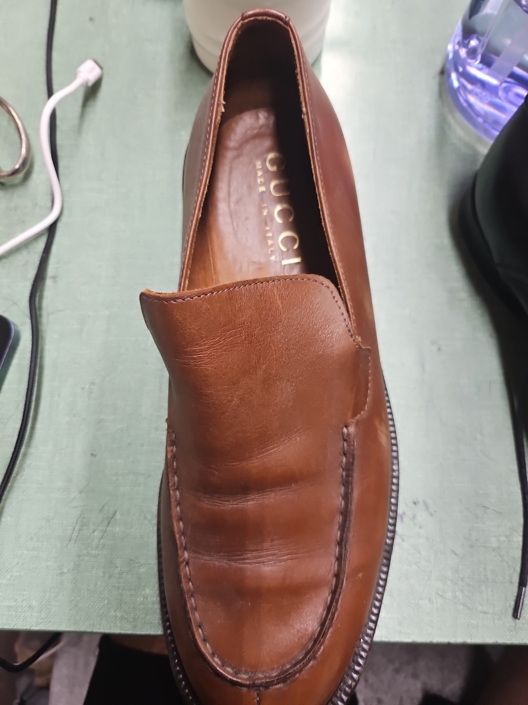 Gucci, a high-end Italian fashion brand known for its luxury goods Brown Leather