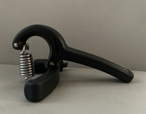 Modern art piece, broken hand gripper: symbol of resilience.