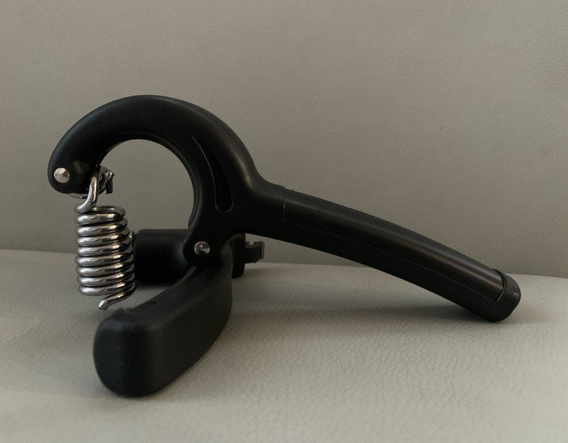 Modern art piece, broken hand gripper: symbol of resilience.