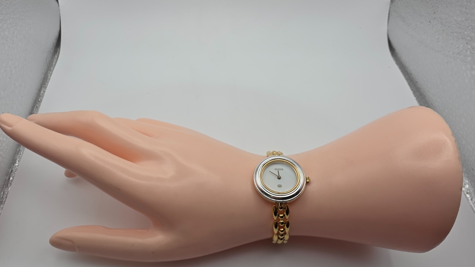 Gucci 1100L  Lady's Gold Plated Bracelet Watch with Six Interchangeable Bezels.