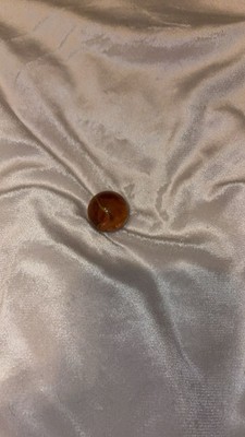 Vintage translucent brown glass marble swirl pattern.