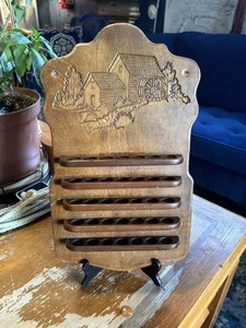 vintage wooden thimble display shelf featuring a water mill carving.