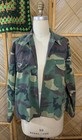Vintage 1980s USA-made green camouflage ranger shirt with button front, two chest flap pockets, and ribbed cuffs on mannequin.