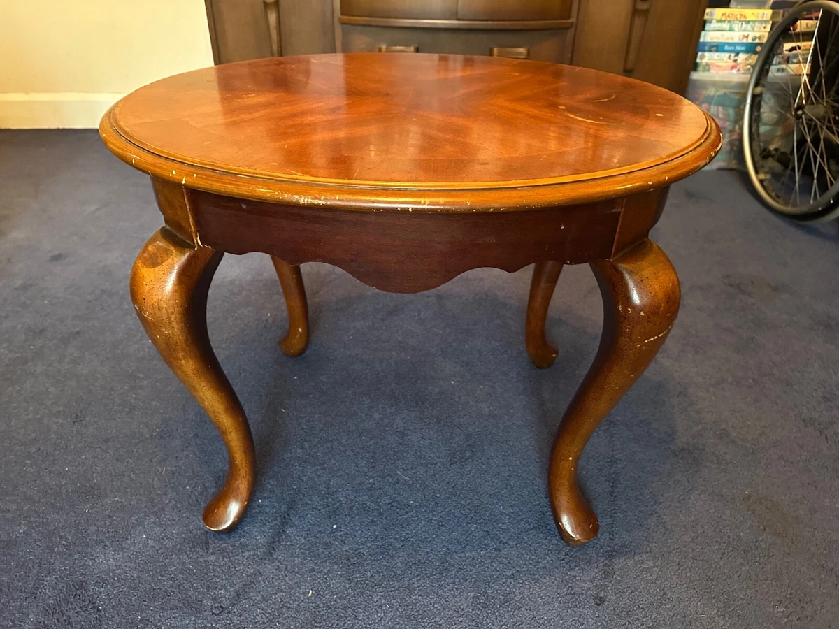 Solid brown wood oval coffee table with curved removable legs