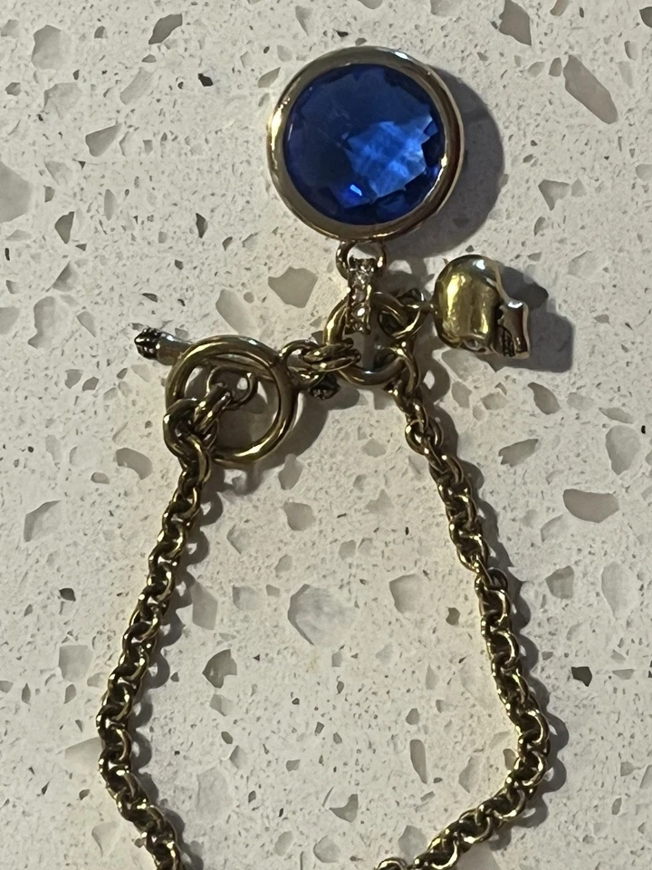Juicy Couture Goldtone Skull Charm Bracelet With Faux Blue Stone Costume Jewelry - Image 4 of 4