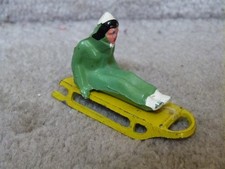 VINTAGE Barclay Toy Lead Figure SITTING WOMAN IN GREEN on Yellow Sled 2.75" L3