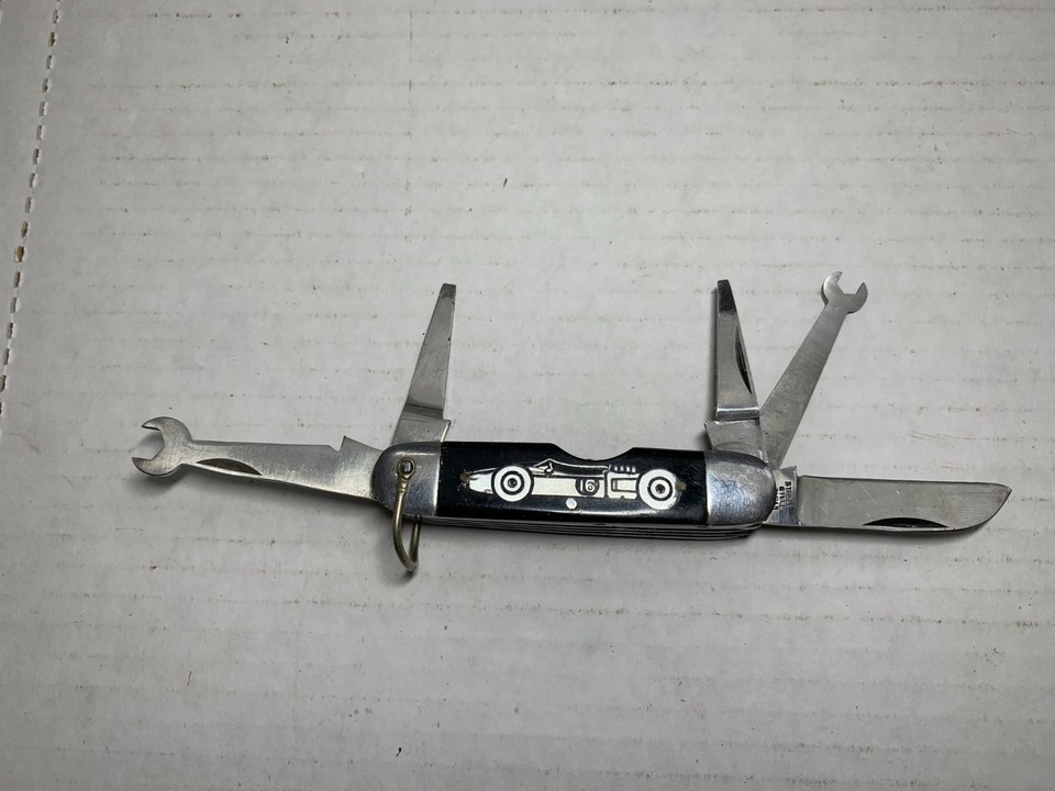 A 1960s Strombecker slot car multi-tool pocket knife made in Japan — two collector worlds colliding in one tiny, mind-bending object.