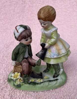 4.5'' Lefton Figurine Mother Helping Son Put On Boots...why are her legs Green?
