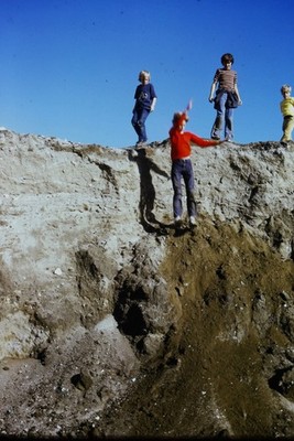 c1970's Kodachrome 35mm Slide, Kids Jumping Dirt Hill Playtime Fun red blue