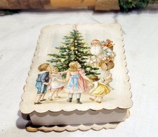 Christmas Santa Themed Chocolate Candy Box. Children about Decorated, lit Tree