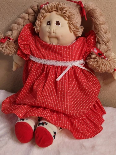 Vintage Cabbage Patch Kid 1985 soft face, light-haired doll in red dress