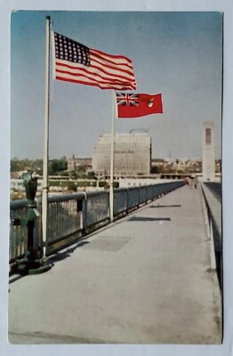 Postcard Midway between the two flags an imaginary line boundary Canada USA