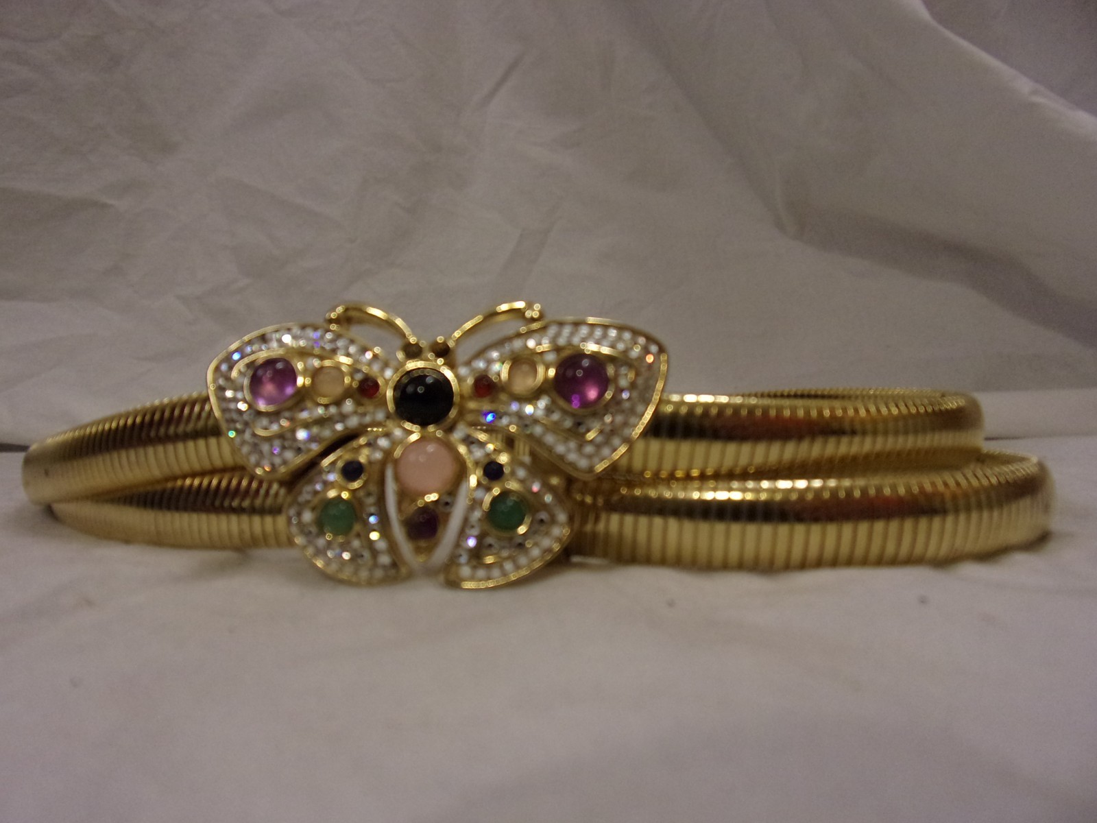 Gold metal stretch belt with jeweled butterfly buckle