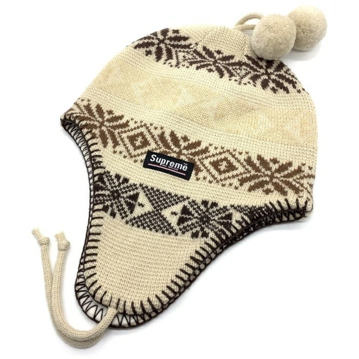 Supreme ancien bonnet tricoté laine cache oreilles motif neige bombon ivoire fabriqué en occasion
