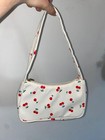 Shoulder bag with cherry design.