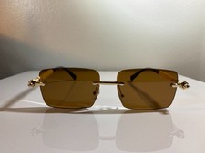 Men's rectangular, rimless sunglasses with brown lenses and gold  white frame.