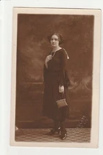 stylishly dressed woman with pearl necklace and purse rppc postcard