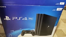 ps4 pro with 2 controllers and a headphone