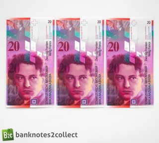 SUIZA: 3 x 20 billetes de franco suizo con números de serie consecutivos.
