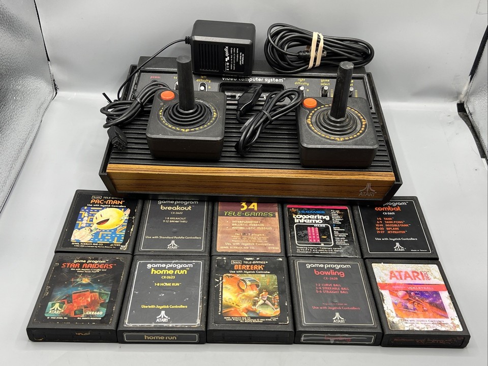 A fully tested Atari 2600 woodgrain bundle with 10 games and OEM cords — plug-in-and-play retro nostalgia that doubles as a shelf trophy.