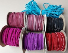Vintage lot of suede lace spools, mauve, red,...