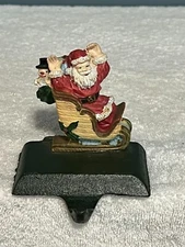 VINTAGE STOCKING HANGER CAST IRON SANTA SLED
