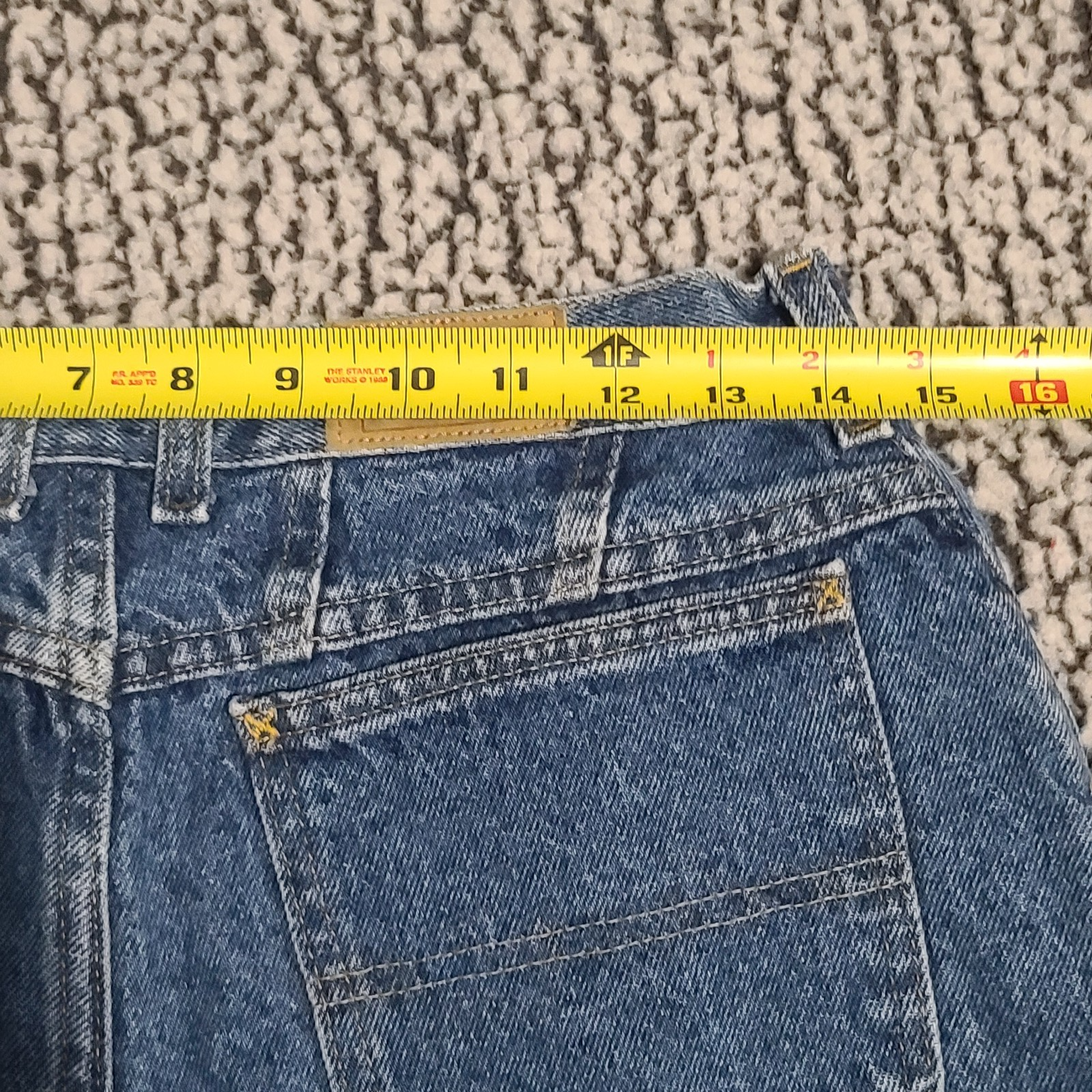 L.L.Bean high-waisted mom jeans, blue denim, size 12, with yellow measuring tape across the waistband.