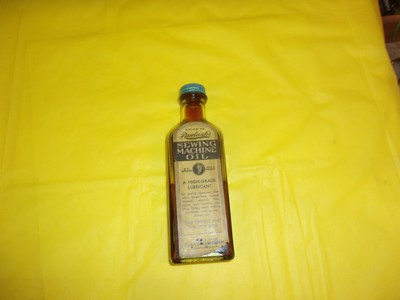 VINTAGE RAWLEIGH's SEWING MACHINE 3oz. EMBOSSED GLASS BOTTLE WITH PAPER LABEL!!!