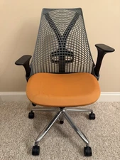 Herman Miller Sayl Office Chair – Orange Seat, Graphite Back, Adjustable Arms