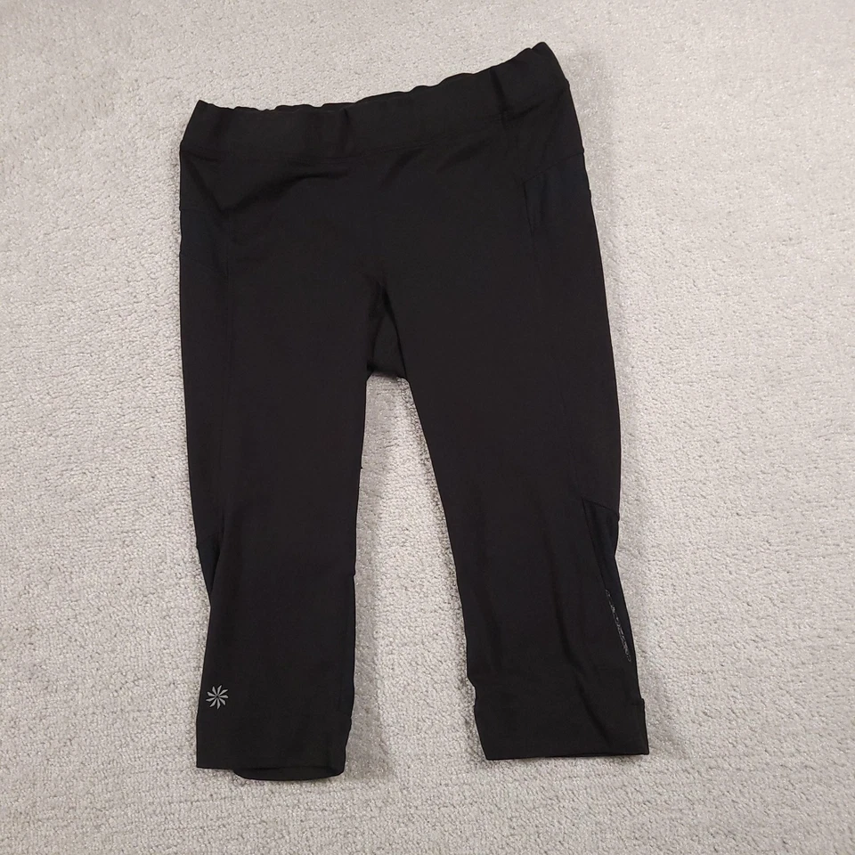 Leggings cortos Athleta para mujer medianos negros de malla bolsillo capri elásticos gimnasio activo Foto 2 de 4