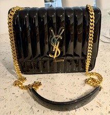Yves Saint Laurent, cross body black pattern leather purse with gold accessories