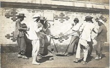 Old RPPC China Workers Using Unusual Tamper to Flatten Ground Construction
