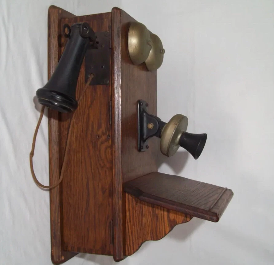 Old phone, Vintage telephone with wooden body and a gold tube.