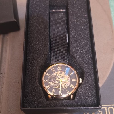 Forsining Skeleton Automatic watch gold-tone case and a black mesh band