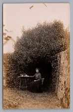 c.1903 RPPC Lady Seated Outdoors Flower Basket Hidden Summer Garden Old Postcard
