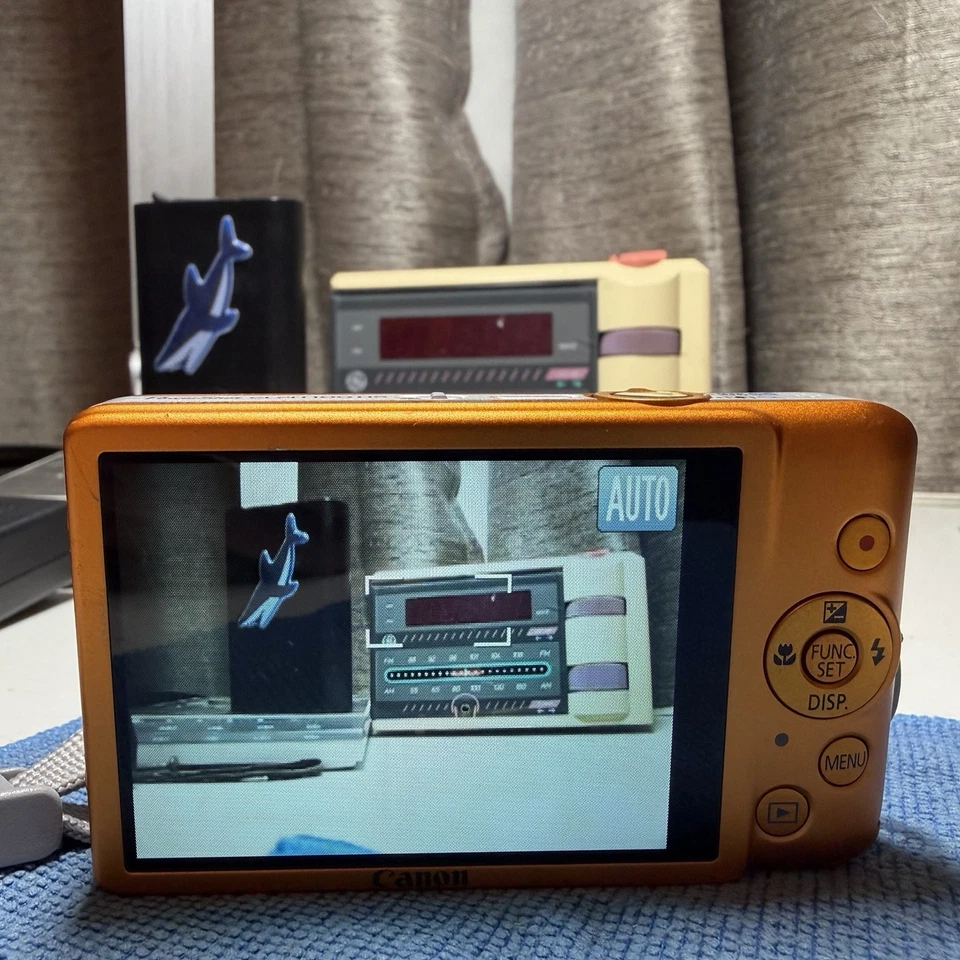 Cámara digital Canon PowerShot ELPH 100 HS 12 MP 4X zoom óptico naranja probado Foto 2 de 4