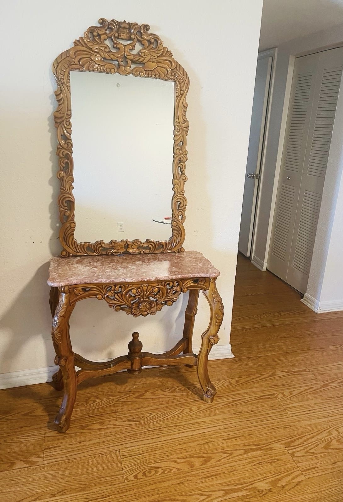 Vintage console table with ornate mirror and marble top