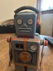 Gray and Orange Marx Japanese windup walking robot with intergrated wind key.