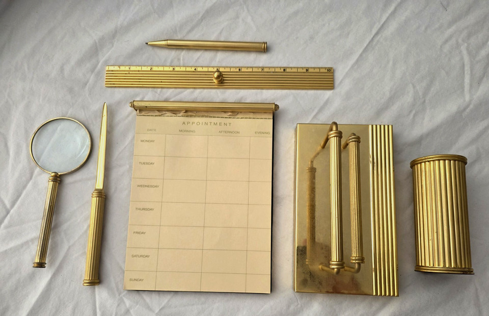 A rare 7-piece solid polished brass mid-century desk set — the kind of cohesive, weighty ensemble that turns any desk into a power statement.