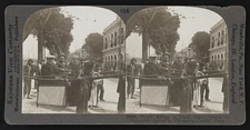 People riding in open chairs swung on poles and carried by Chinamen, Canton,