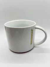 Starbucks 2012 White Coffee Mug, Gold Letters Red Trim Around Bottom 16 oz.