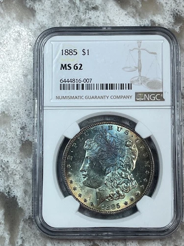 1885 Morgan Dollar NGC MS62 with Rainbow Obv and Crescent Rev