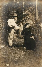 RPPC Man Dressed as Fancy Cowboy With Fur Chaps Lasso Next To Woman in Forest