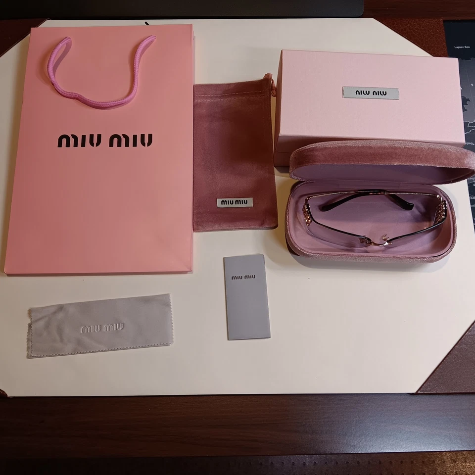 Gafas de sol para mujer Miu Miu Mu A51S marco dorado marrón sin montura Foto 2 de 4